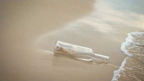 Empty wine bottle on sea beach washes foaming water Stock Footage 253257921
