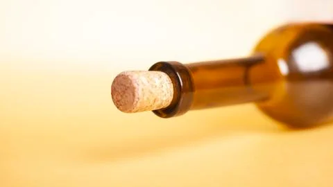 Empty wine bottle on a yellow background closeup. Стоковые фото
