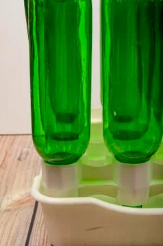 Empty wine bottles in a plastic dryer on the table. Stock Photos