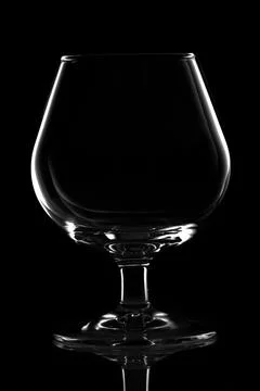 Empty wine glass isolated on black, cognac glass Stock Photos