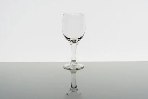 Empty wine glass with reflection on background, front view Stock Photos