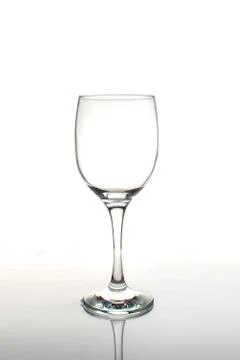 Empty wine glass with reflection on a white background Stock Photos