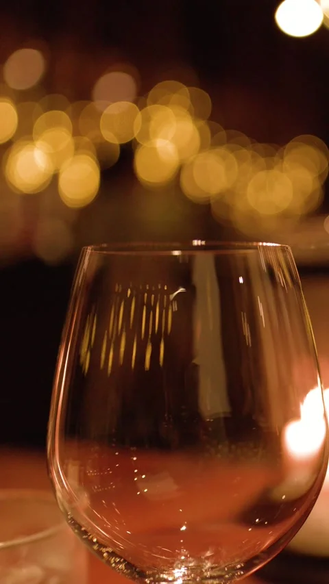 Empty Wine Glass on Restaurant Table with Warm Candlelight Bokeh Vídeos de archivo 326022244