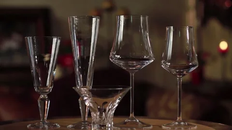 An empty wine glass sitting on a table Stock Footage 155451292
