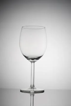 Empty wine glass on a white background with vignetting Stock Photos