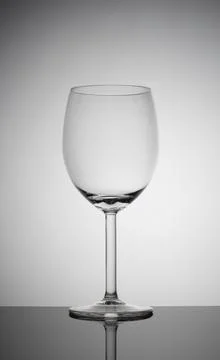 Empty wine glass on a white background with vignetting Foto stock