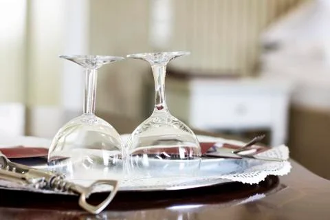 Empty wine glasses and corkscrew in the bedroom Stock Photos