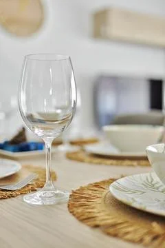 Empty wine glasses and dinnerware served on dining table Foto stock
