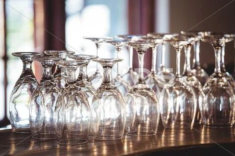 Empty Wine Glasses Arranged On Bar Counter At Bar