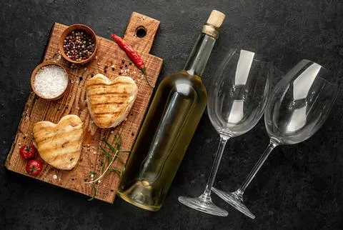 Empty wine glasses with a bottle on a dark table Stock Photos