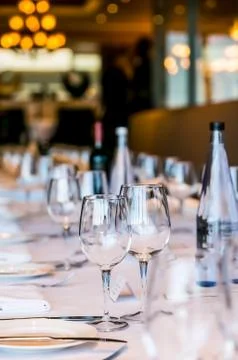Empty Wine Glasses on a long table for gala dinner 写真素材
