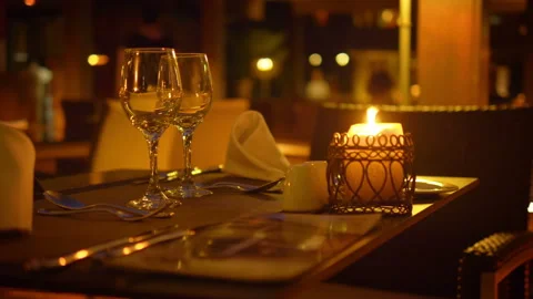 Empty wine glasses on a table in a restaurant at night in 4k slow motion 60fps Video stock 133265211