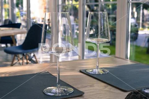 Empty wine glasses on the table in restaurant. Vintage styled photography, pr Stock Photos