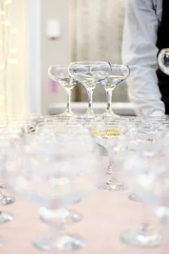 Empty wine or champagne glasses on table are in pyramid. Stock Photos