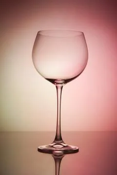 Empty wineglass for red wine on diffusion lit background in abstract composit Stock Photos
