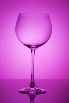 Empty wineglass for red wine on diffusion lit background in abstract composit Foto stock