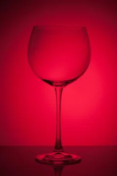 Empty wineglass for red wine on diffusion lit background in abstract composit Stock Photos
