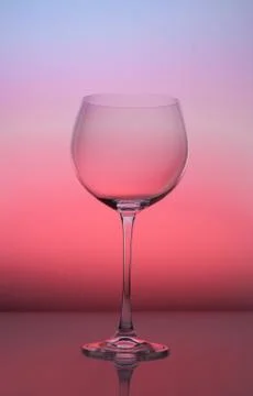 Empty wineglass for red wine on diffusion lit background in abstract composit Stock Photos