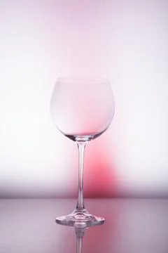Empty wineglass for red wine on diffusion lit background in abstract composit 스톡 사진