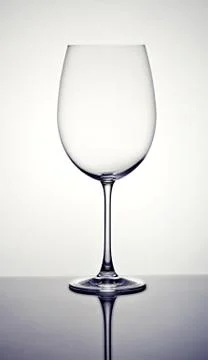 Empty wineglass on a reflective surface Stock Photos