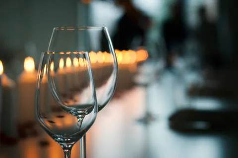 Empty wineglasses on a festively decorated dining table with candles Stock Photos