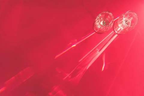 Empty wineglasses with flecks on red background flat lay Stock Photos
