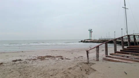 Empty winter beach and calm sea on cloudy day Stock Footage 340358101