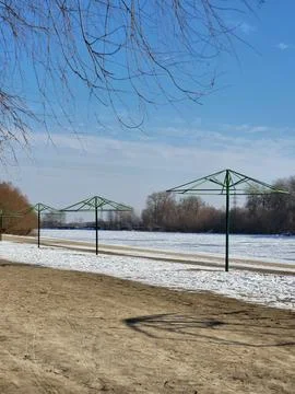Empty winter park with metal structures outdoors Stock Photos