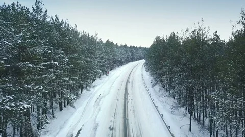 Empty Winter Road Aerial View Flight among the snowy Trees through the Forest Stock Footage 86440379