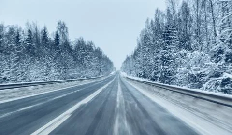 Empty winter road in a snow storm in the twilight when snow is flying. Concept Stock Photos