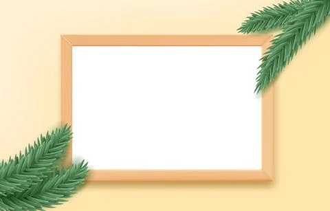 Empty wood frame on the table with pine branches. 스톡 일러스트