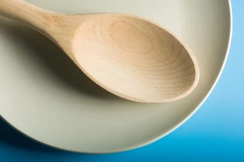 Empty Wood Spoon in blue background Stock Photos