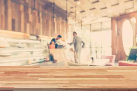 Empty wood table and Blurred background display at coffee shop with space for Stock Photos