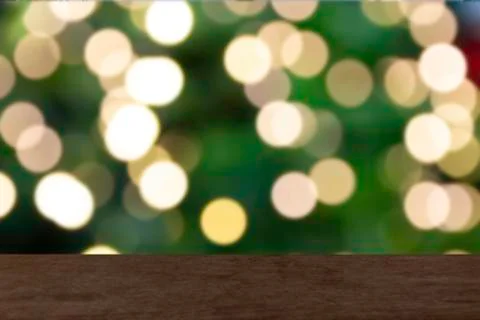Empty wood table with blurred light gold bokeh and green background. Stock Photos