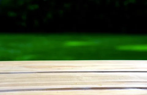 Empty wood table with free space over green background. For product display Stock Photos