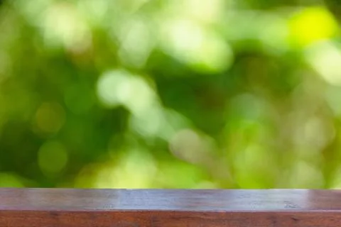 Empty wood table top on abstract blurred green from tree 스톡 사진