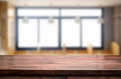 Empty of wood table top on blur of window glass in the morning background. fo Stock Photos