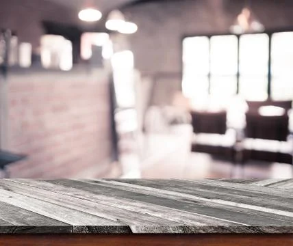 Empty wood table top with coffee shop blur with bokeh background Stock Photos