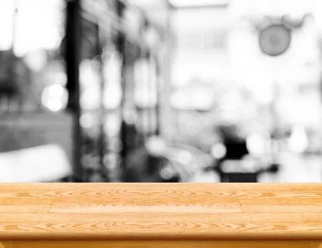 Empty wood table top with coffee shop blur with bokeh background,Product di.. Stock Photos