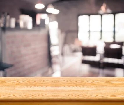 Empty wood table top with coffee shop blur with bokeh background,Product di.. Stock Photos