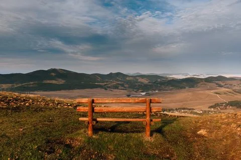 Empty Wooden Bench Overlooking Mountain Landscape Stock Photos