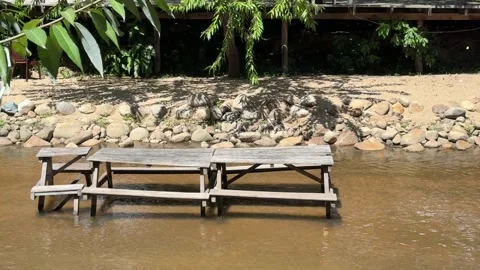 Empty wooden bench in water stream in countryside of Cambodia Stock Footage 336781679