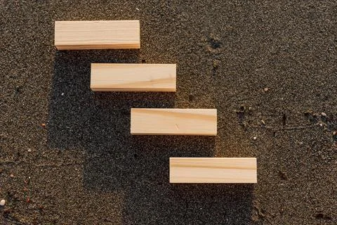 Empty wooden blocks with copy space for text on sandy summer beach background Stock Photos