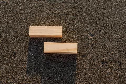Empty wooden blocks with copy space for text on sandy summer beach background Stock Photos