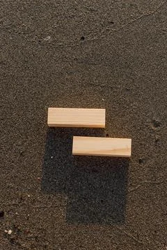 Empty wooden blocks with copy space for text on sandy summer beach background Stock Photos