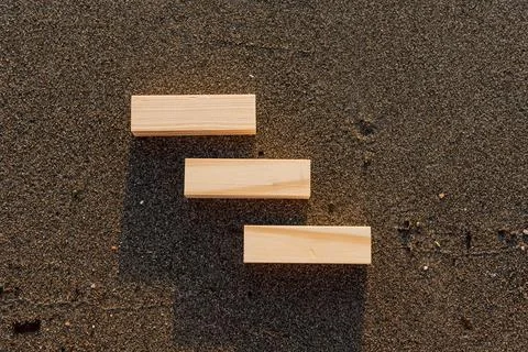 Empty wooden blocks with copy space for text on sandy summer beach background Stock Photos