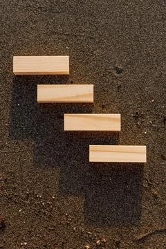 Empty wooden blocks with copy space for text on sandy summer beach background Stock Photos