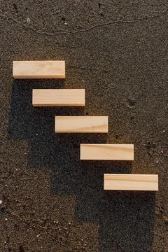 Empty wooden blocks with copy space for text on sandy summer beach background Stock Photos