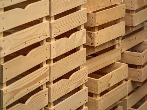Empty wooden boxes or containers for fruit and vegetables stacked in warehous Stock Photos