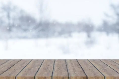 Empty wooden counter table or bench and winter scenery with white snow fall.. Stock Illustration